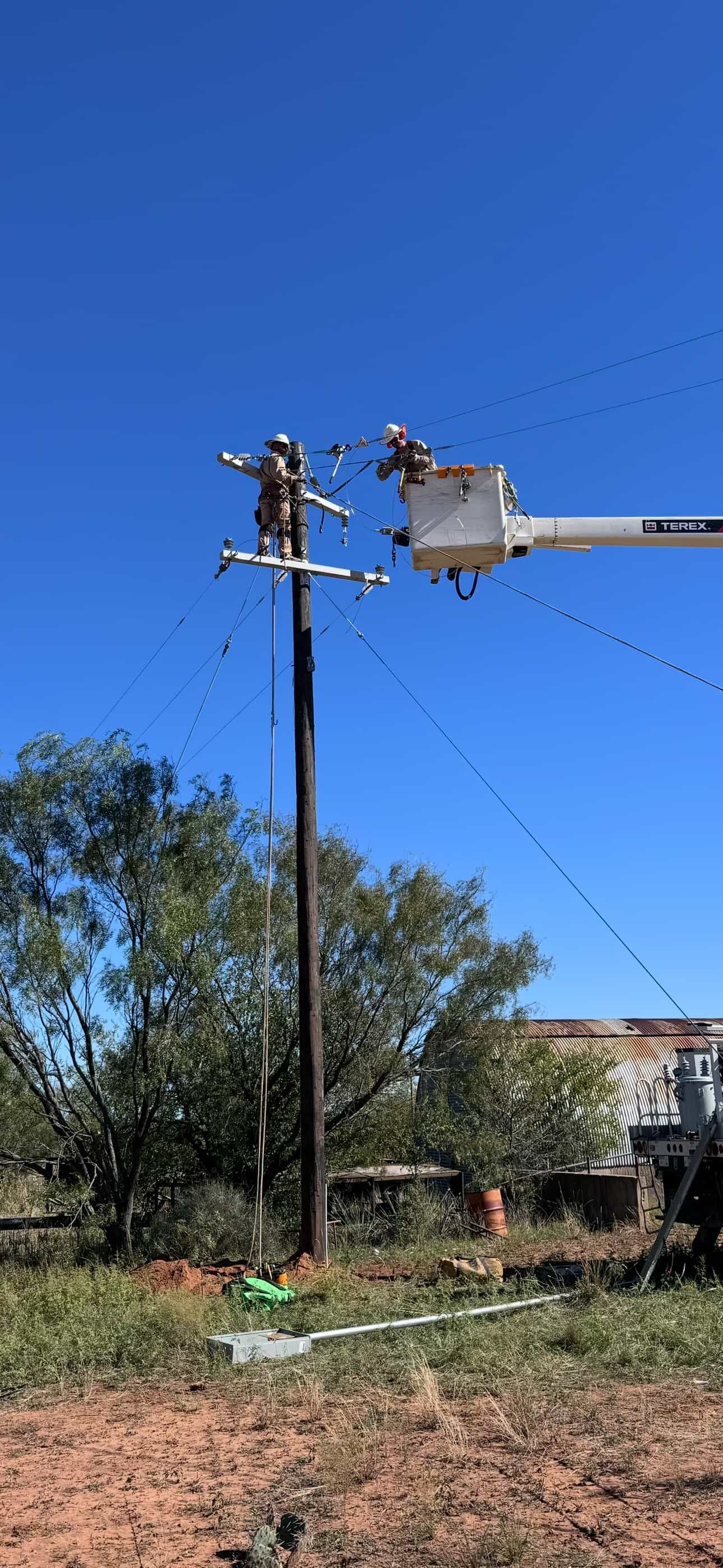 Jude Jolma smiling with his daughter at a community lineman event