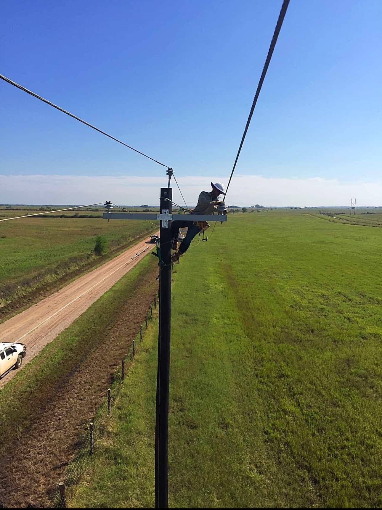 Jude Jolma smiling with his daughter at a community lineman event