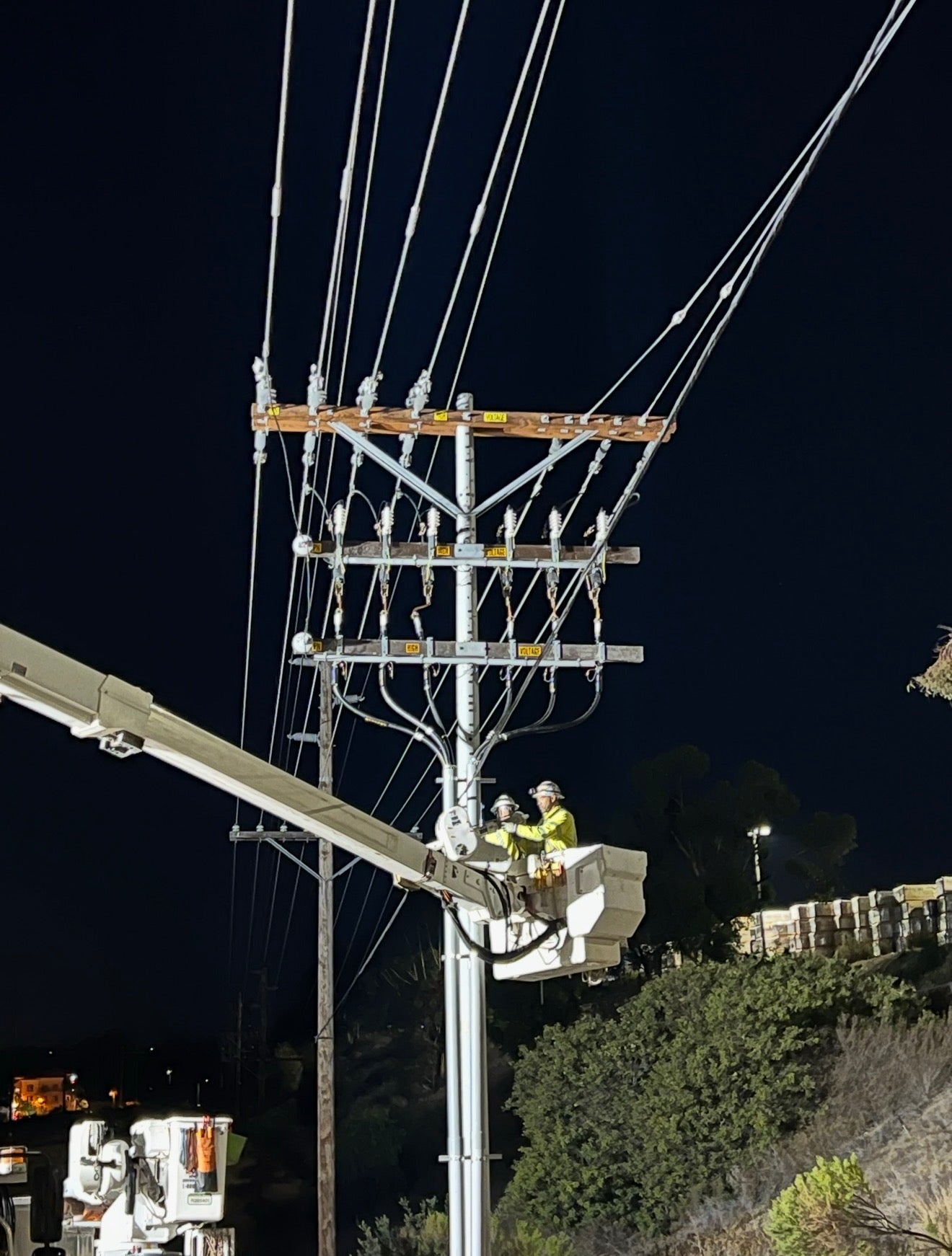 Jude Jolma sitting in an office wearing a beige electrical company shirt and cap