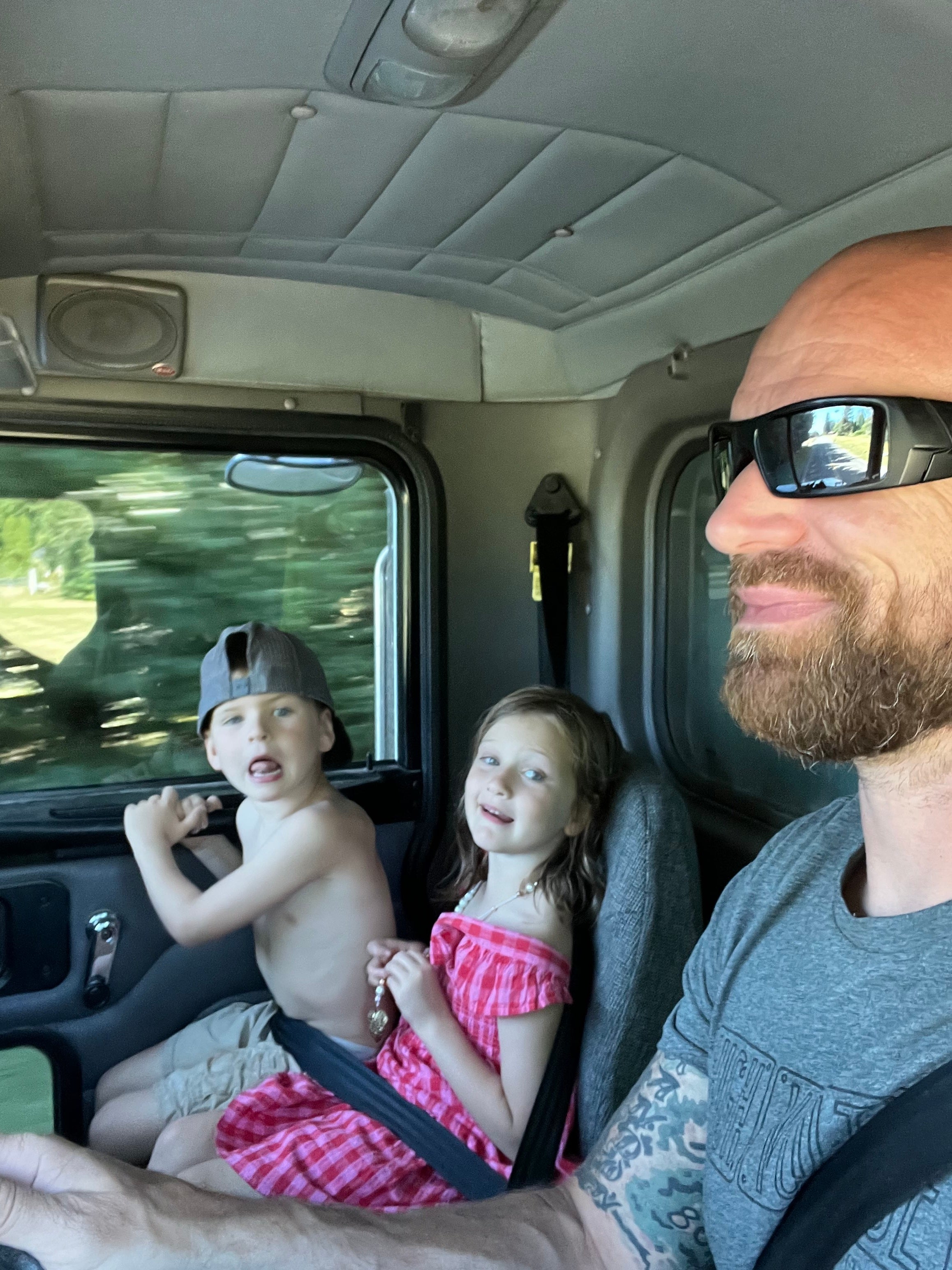 Jude Jolma driving with his two children, enjoying family time together on the road