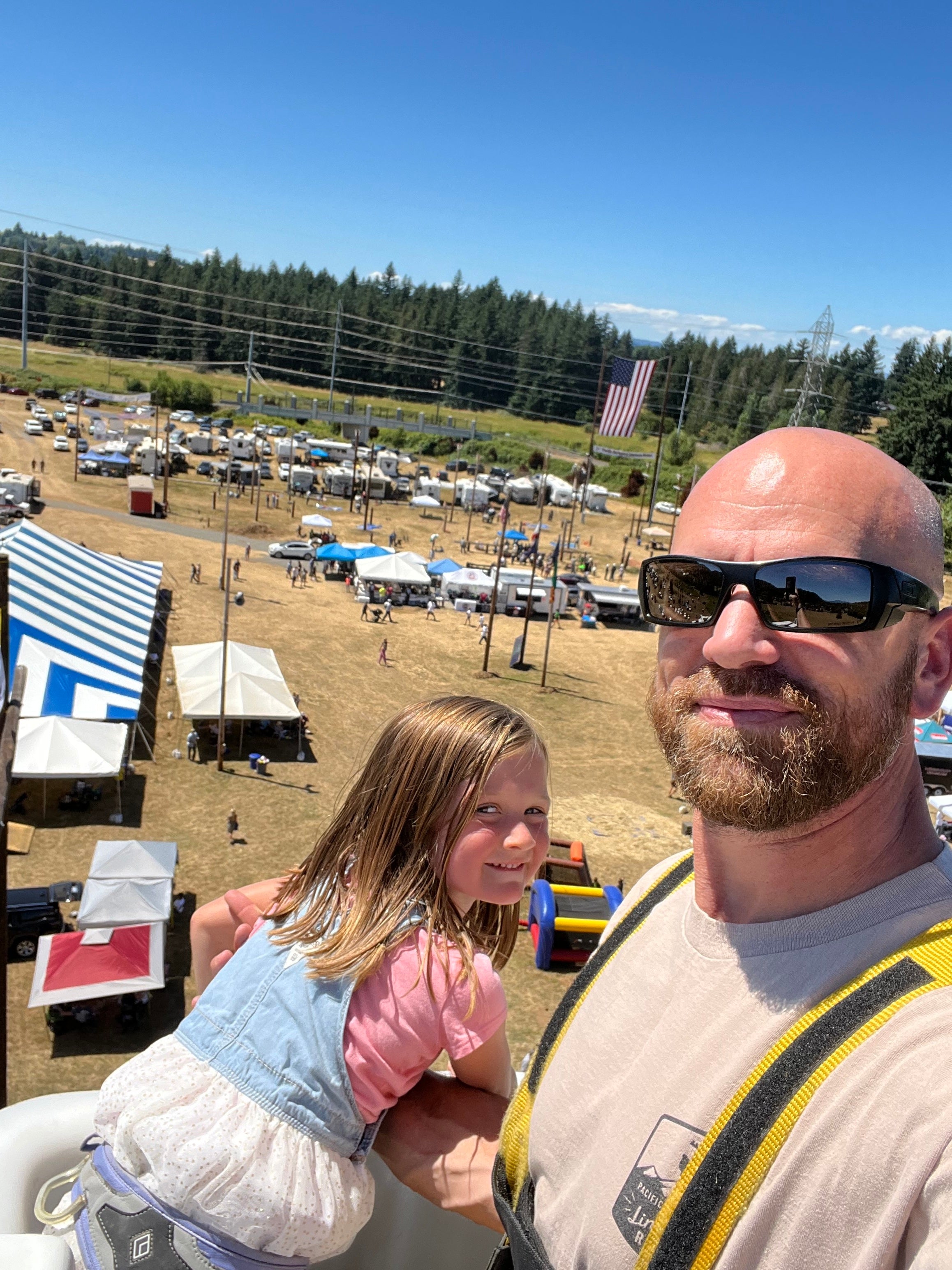 Jude Jolma smiling with his daughter at a community lineman event