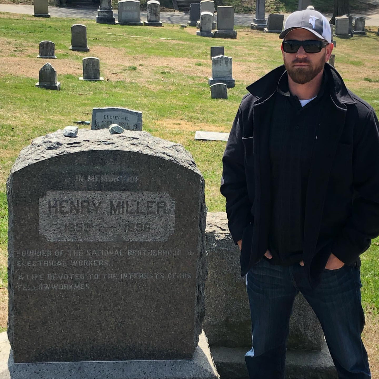 Jude Jolma visiting the gravesite of Henry Miller, honoring the legacy of the International Brotherhood of Electrical Workers.