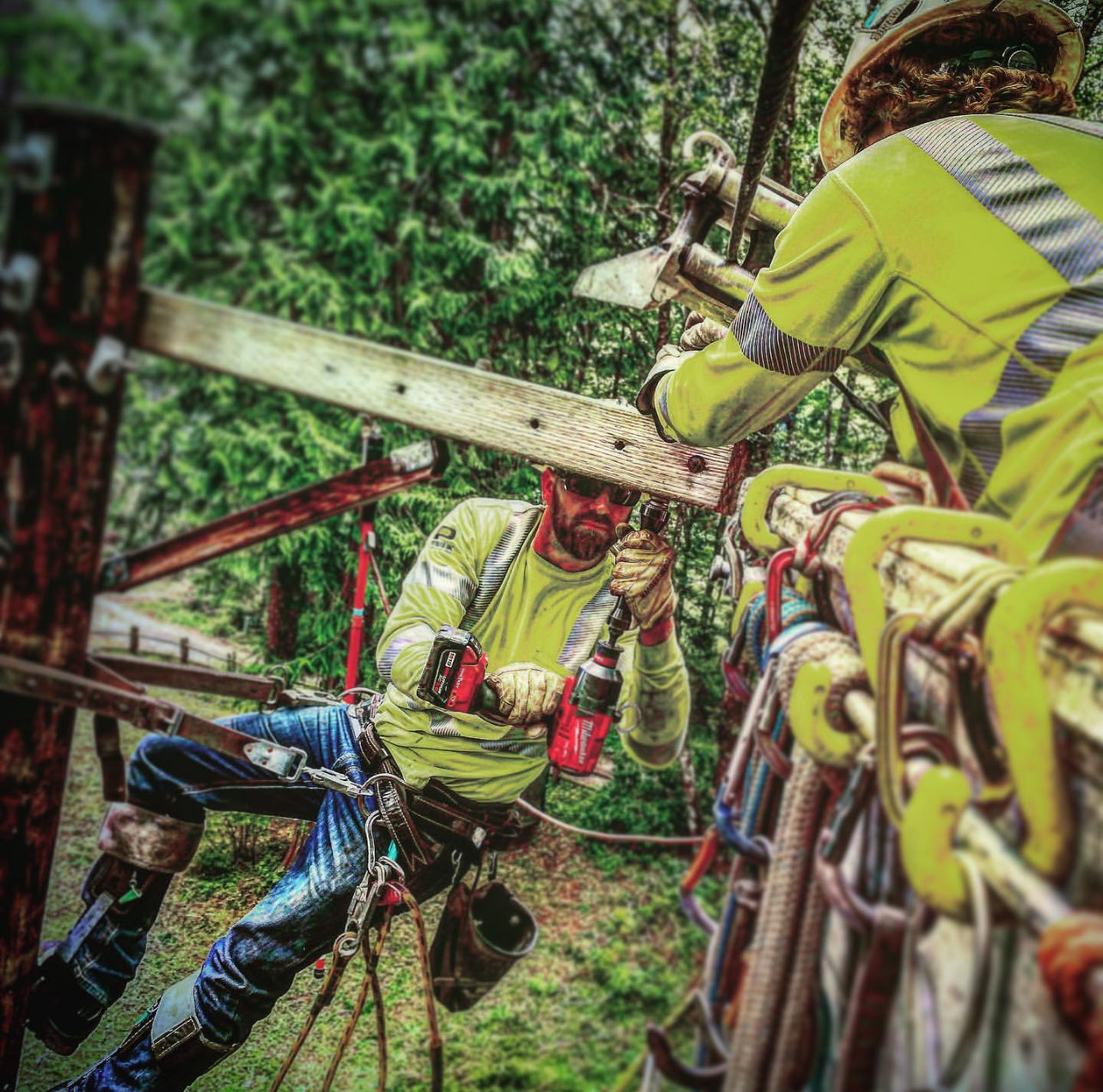 Jude Jolma and crew working on high-voltage lines, securing equipment and performing maintenance while suspended on the pole