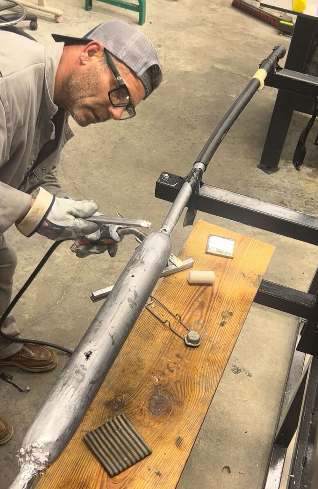 Mark Savage welding and sealing a high-voltage cable splice during underground power line preparation.