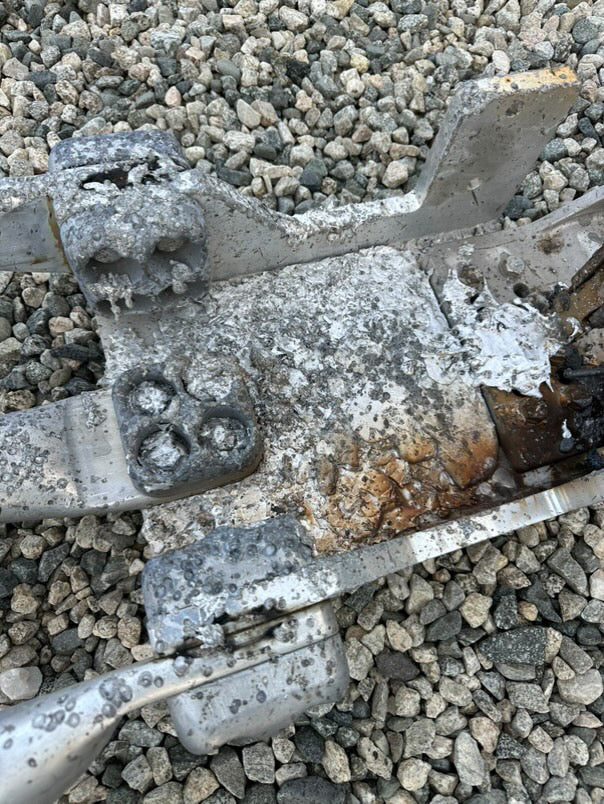 Burnt and damaged electrical components on gravel ground after failure of a 500kV disconnect switch