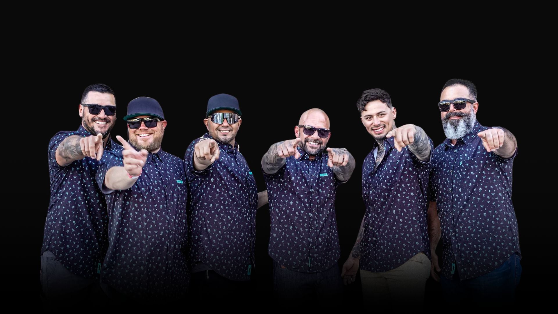 A group of six men wearing matching highline button up shirts, smiling and pointing at the camera — High Voltage Industries custom gear