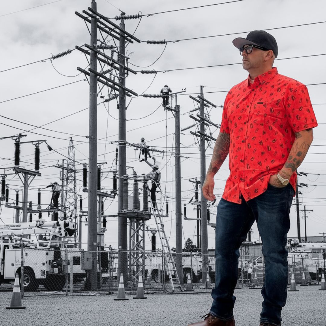 Sergio wearing his Distro Button Up with a cap on outdoor