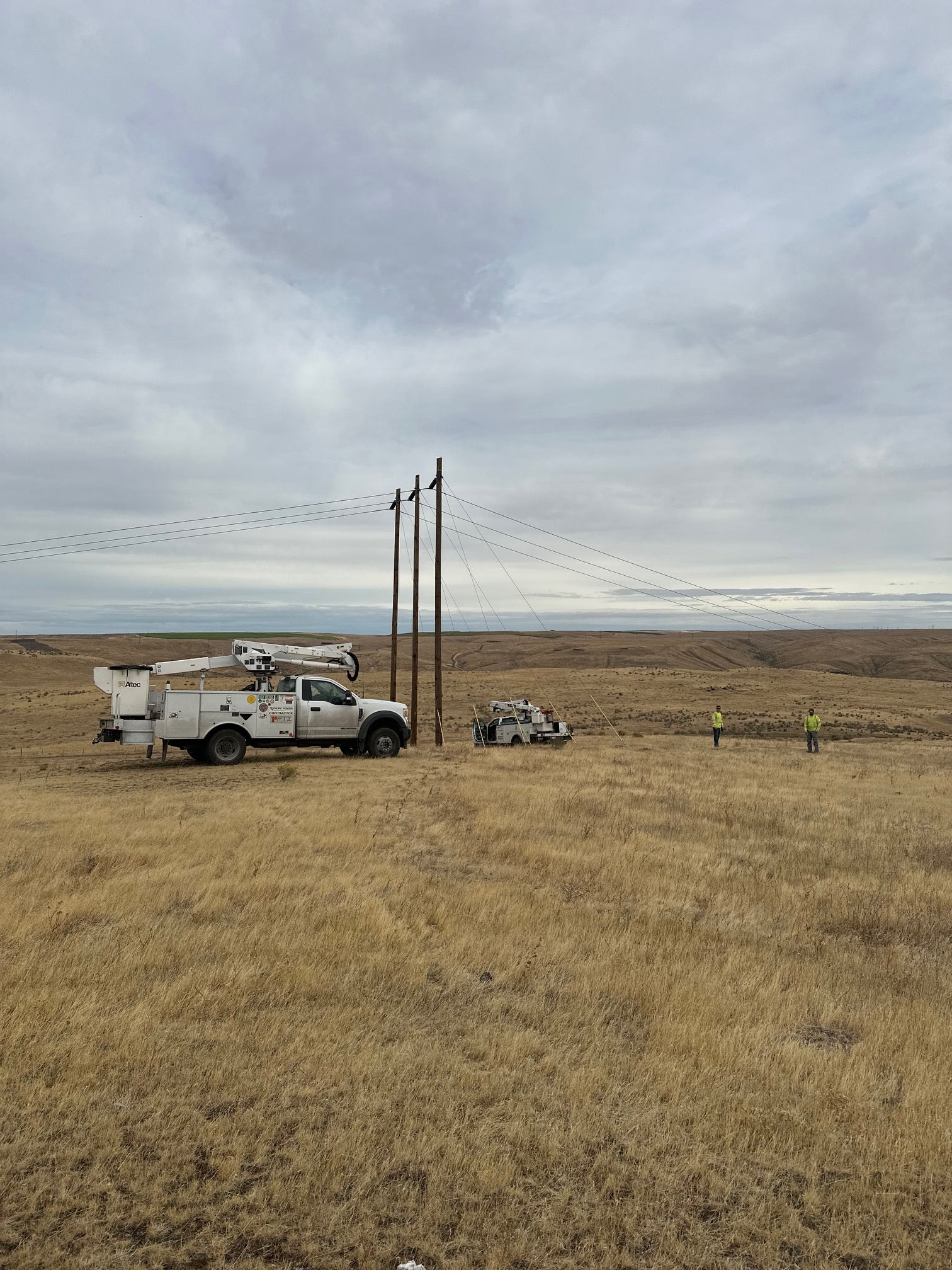 Jude Jolma sitting in an office wearing a beige electrical company shirt and cap