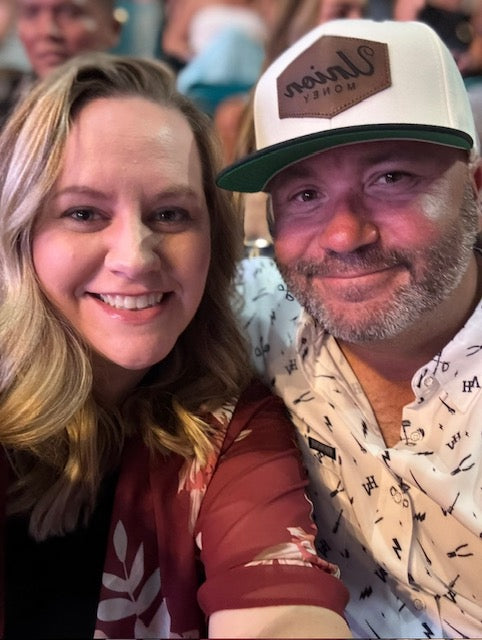 Sammy Micco smiling with his wife at an event.