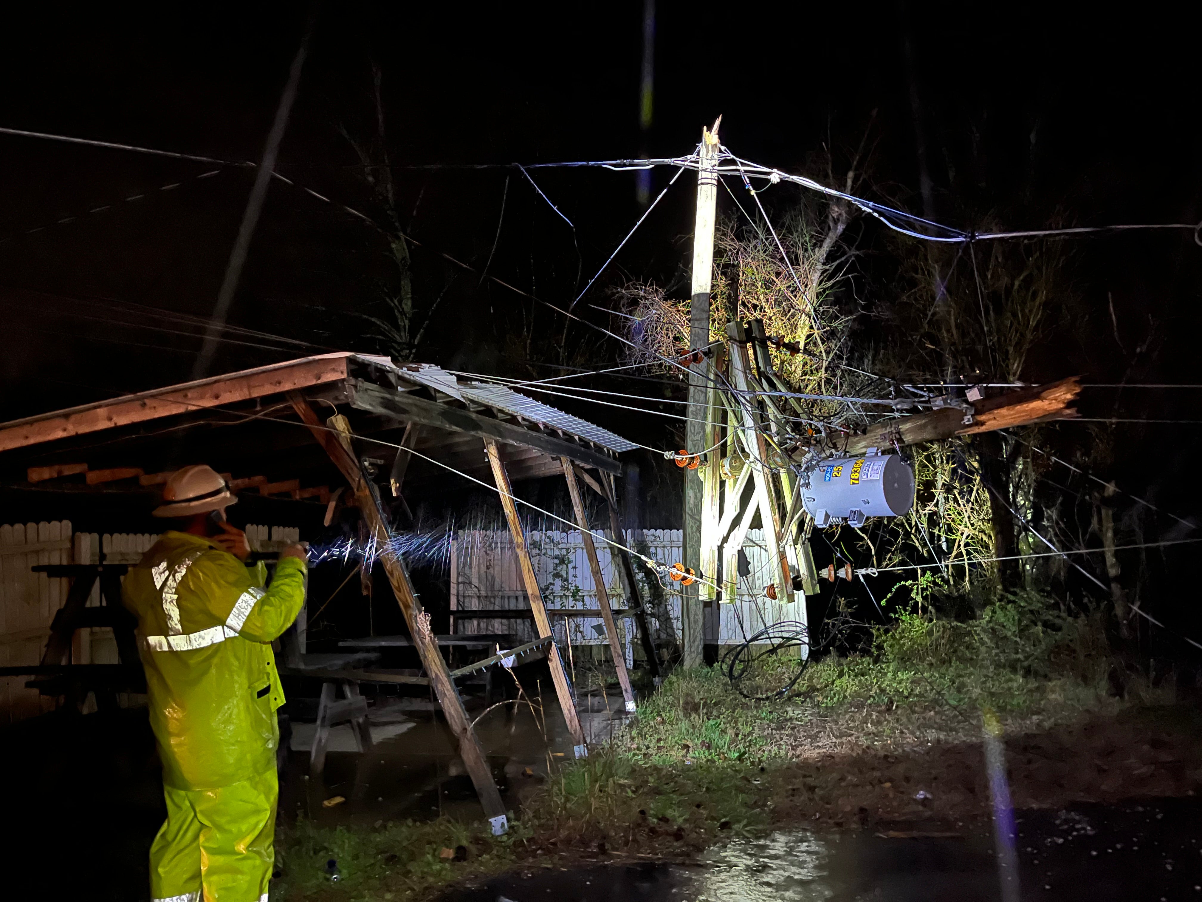 Jude Jolma sitting in an office wearing a beige electrical company shirt and cap